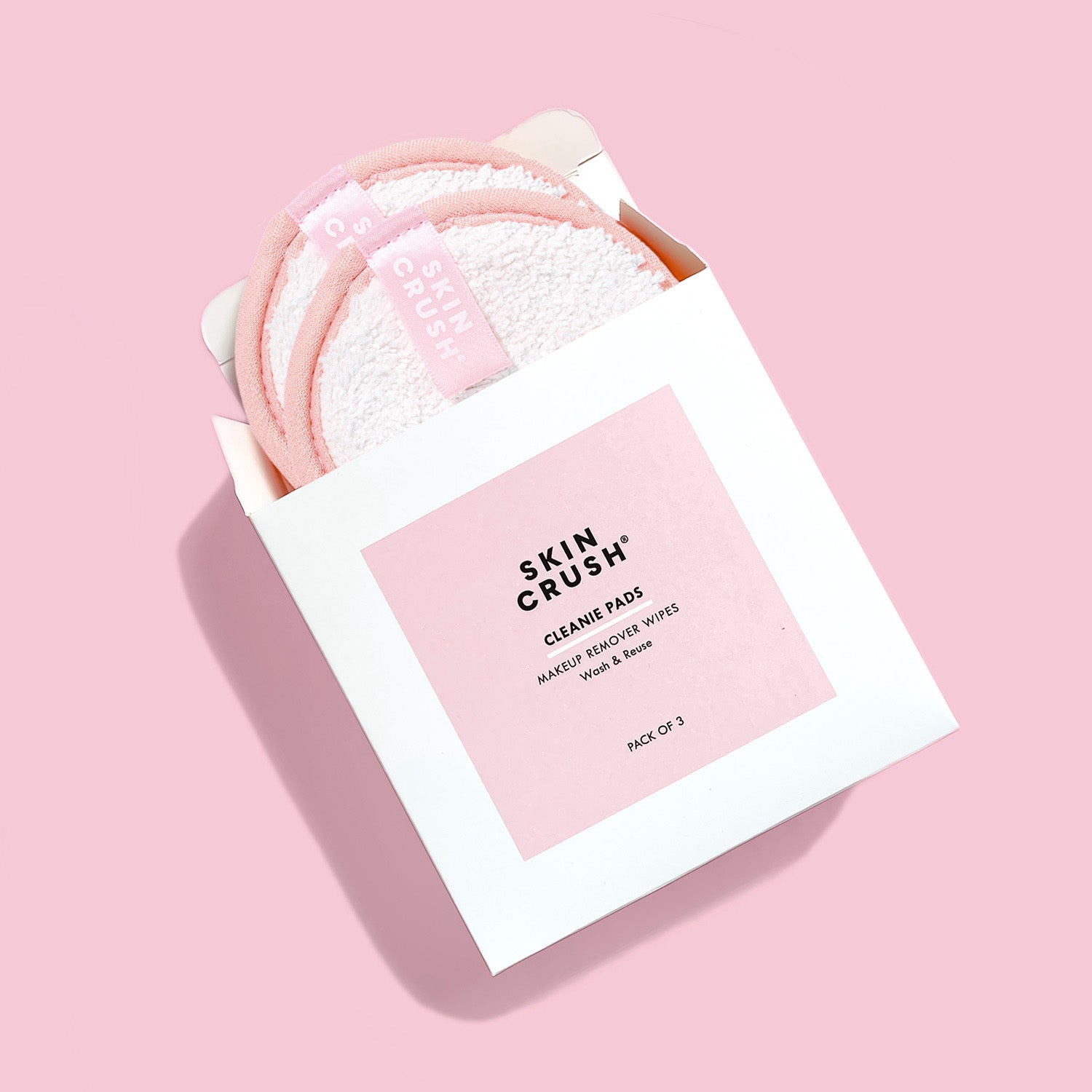 white and pink packaging box for skin crush cleanie pads make up remover wipes pack of 3 on pink background 